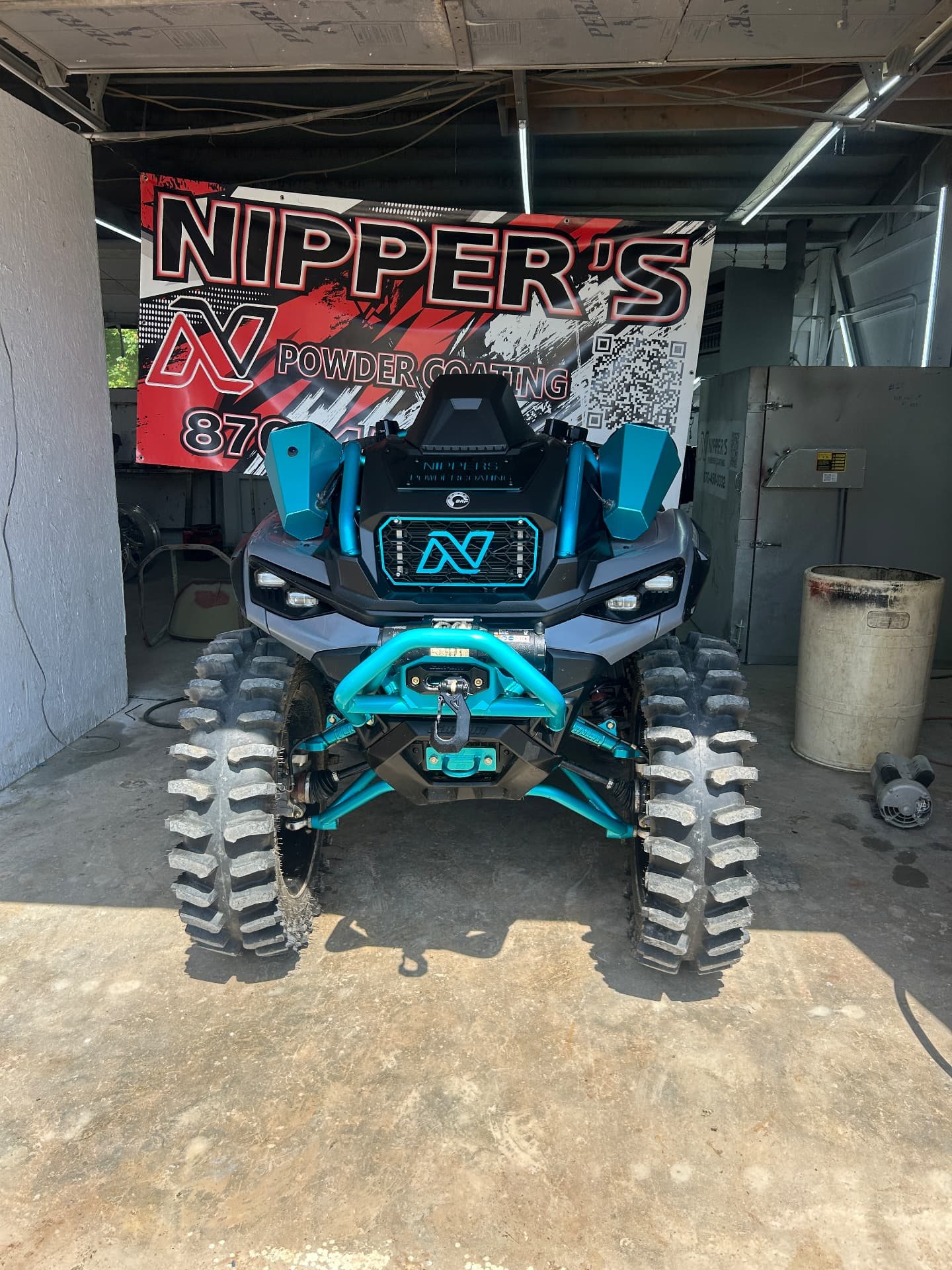 Teal powder-coated ATV frame by Nipper's Powder Coating